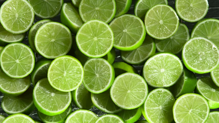 Super Slow Motion Shot of Splashing Fresh Limes. Filmed on High Speed Cinematic Camera at 1000fps. Royalty-Free Stock Footage #1107252711