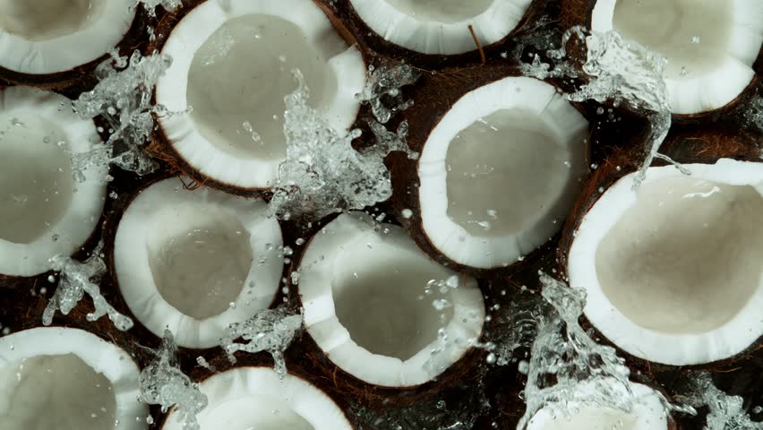 Super Slow Motion Shot of Splashing Fresh Cracked Coconuts. Filmed on High Speed Cinematic Camera at 1000fps.