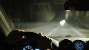 Woman drives a car at might through the suburban area of a big city - Powered by Shutterstock - Get 15% off with code: PIKWIZARD15