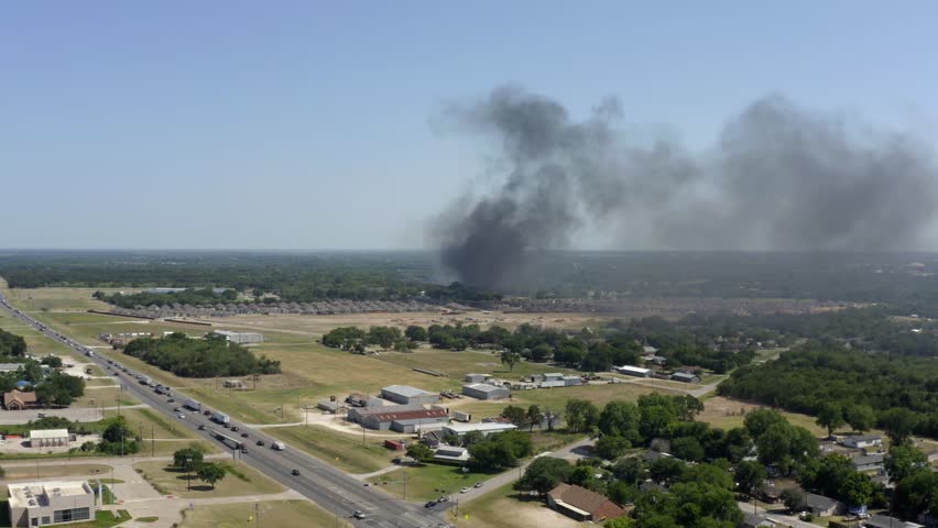 Aerial view overlooking a wildland fire on the countryside of Texas, sunny day in USA