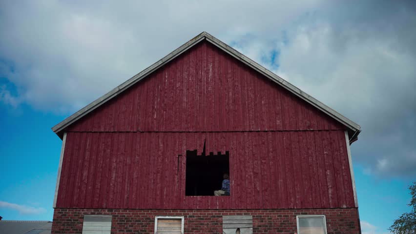 People Inside The Old Barn House For Restoration. Low Angle