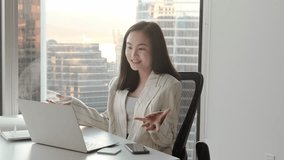 Young Asian business woman communicating by video conference call meeting. Female executive leader or hr manager talking having remote job interview working on laptop in modern office. - Powered by Shutterstock - Get 15% off with code: PIKWIZARD15