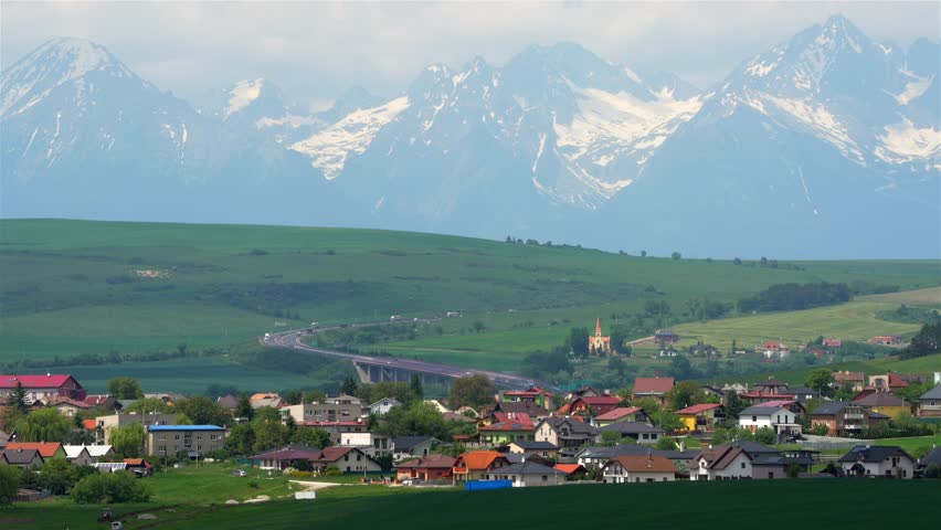 Small town in the foreground in beautiful countryside overlooking the High Tatras, Slovakia.