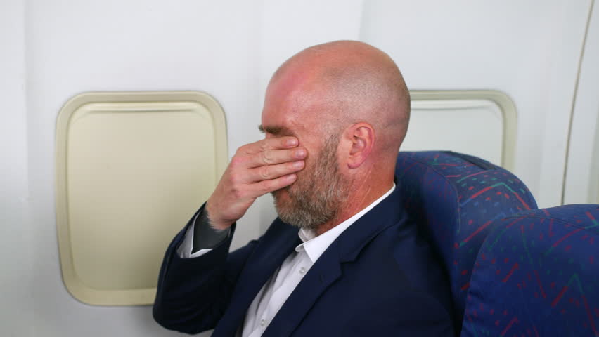 A business man suffering with anxiety on a passenger plane airliner airplane Royalty-Free Stock Footage #1107259149