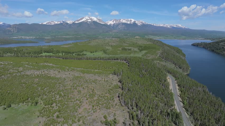 Natural scenery of road around Dillion Reservoir and high mountains backdrop. Colorado Mountains, aerial landscape.