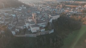 A drone footage over the medieval Comune of Mondaino, Rimini province, Marche, Italy at sunset