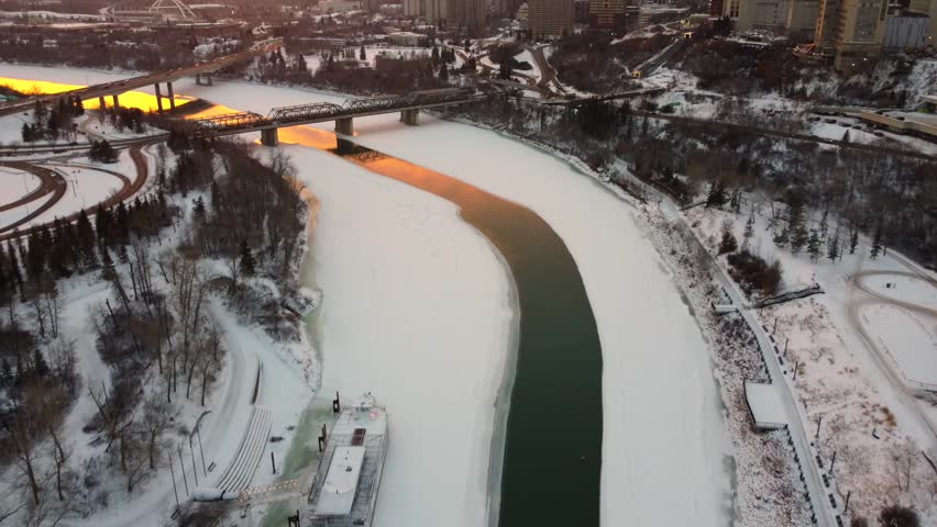 A scenic drone view of overlooking bridges over the North Saskatchewan river during the sunset
