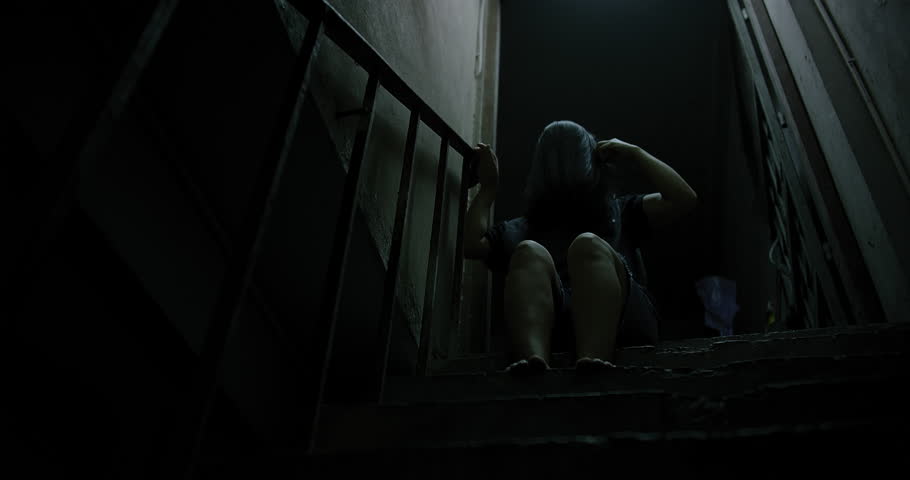 Horror scene of a mysterious Scary Asian ghost woman creepy have hair covering the face sitting on staircase at abandoned house with background dark scene movie at night, festival Halloween concept Royalty-Free Stock Footage #1107265825