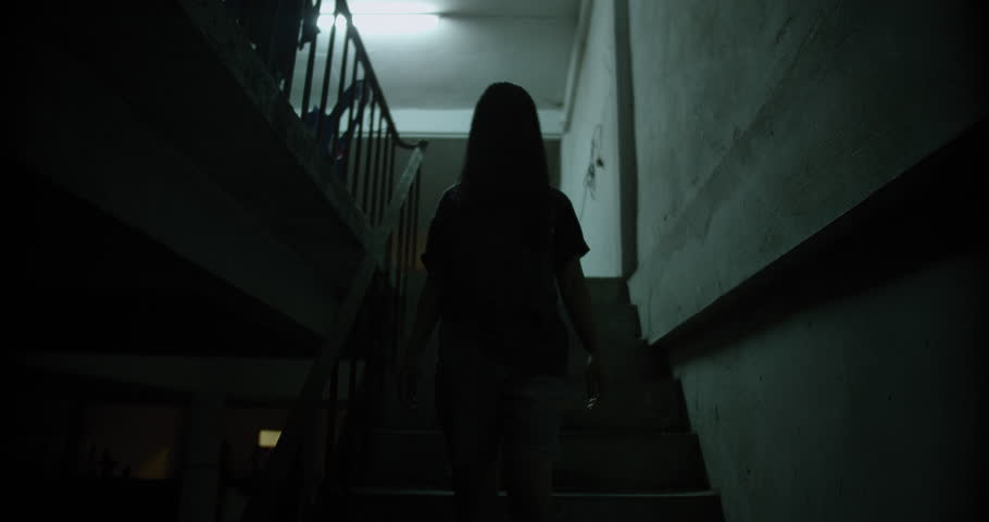 Horror scene of a mysterious Scary Asian ghost woman creepy have hair covering the face walking down on staircase at abandoned house with dark scene movie at night, festival Halloween concept Royalty-Free Stock Footage #1107266305