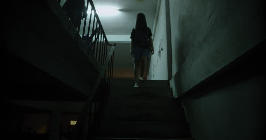 Horror scene of a mysterious Scary Asian ghost woman creepy have hair covering the face walking down on staircase at abandoned house with dark scene movie at night, festival Halloween concept Royalty-Free Stock Footage #1107266307