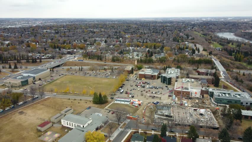 An aerial shot of a parking lot and construction site in Edmonton, Alberta, Canada during fall
