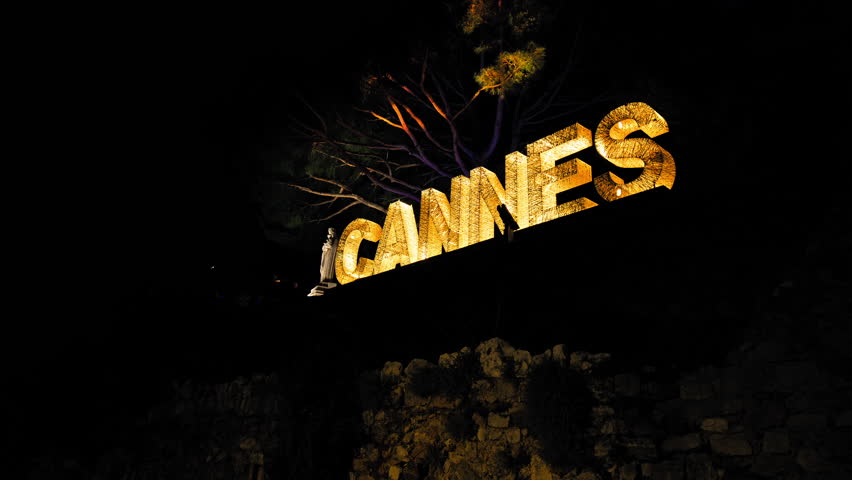Cannes text on top of a mountain lit up at night in Cannes, a sign of the city. Cannes written with light bulbs sparkle at night on the French Riviera, Cote d'Azur. Royalty-Free Stock Footage #1107272239