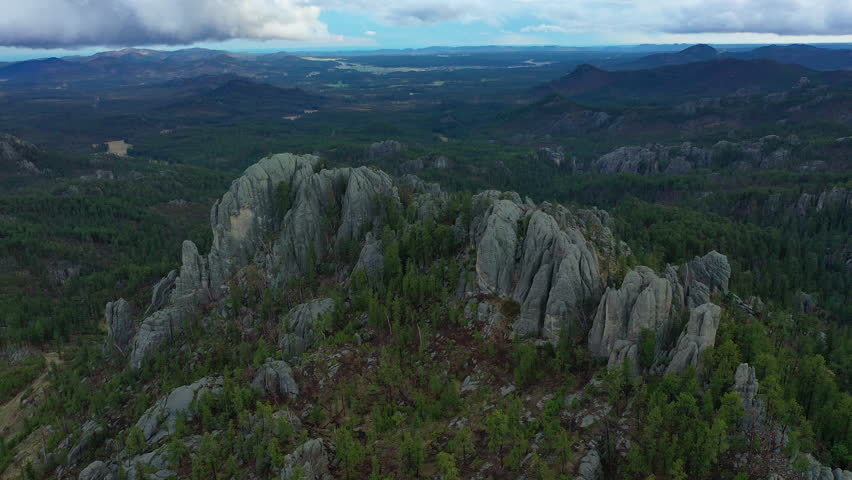 The jagged mountains of the Black Hills are surrounded by trees in SD