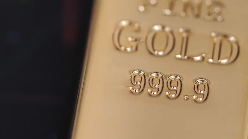 gold bars place on the phone that opens the candlestick chart. and dollar. Fluctuations in gold prices concept. Royalty-Free Stock Footage #1107276353