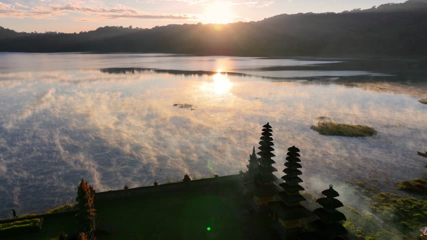 famous Bali tourist attraction, ancient Balinese Hindu temple on a foggy morning at the lake, Pura Ulun Danu temple in Bali, Indonesia. High quality 4k footage Royalty-Free Stock Footage #1107276541