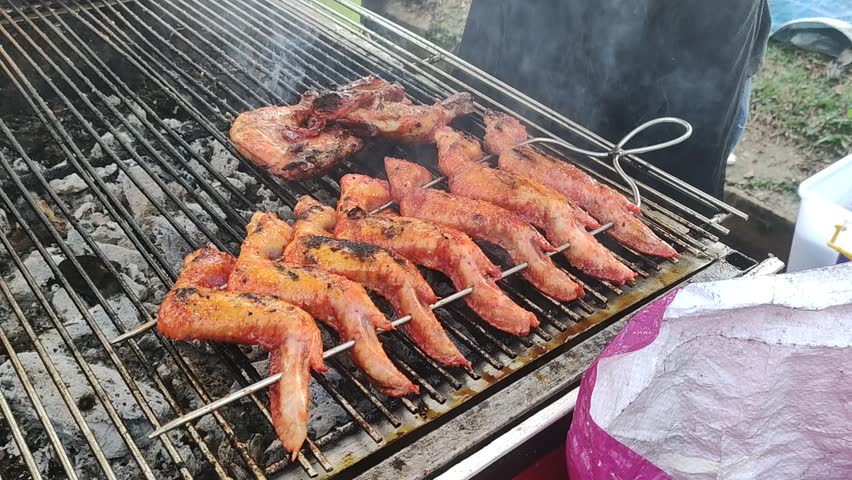 Video of chicken wings grilled over charcoal, culinary festival | Shutterstock HD Video #1107277233