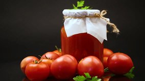 Cooked homemade tomato juice canned in a jar of natural tomatoes.