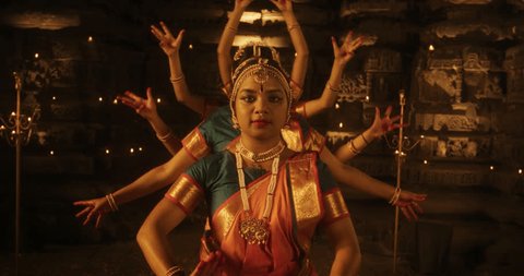 Slow Motion Portrait of CInematic Group of Indian Women Joyfully Dancing Traditional Folk Dance Outside of Authentic Temple. Colorful and Captivating South Asian Cultural Celebration. Zoom out Arkistovideo
