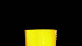 orange slice falling into orange juice glass and making splashes with a black background - Powered by Shutterstock - Get 15% off with code: PIKWIZARD15