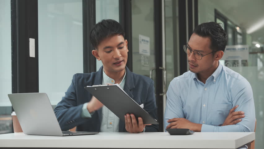 Serious young business asian man supervisor analyse financial report of responsible worker pay attention on mistakes propose correction. insurance agent legal obligations, policy terms conditions Royalty-Free Stock Footage #1107287769
