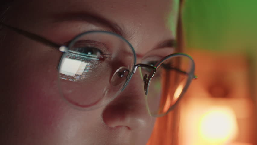 Closeup of Young Adult Women Wearing Reflective Eye Glasses Analyzing Cyber Security Code Data Working Night Concentrating Computer Screen Financial Virus Hacker Female Dark Programmer Crypto BTC 4K Royalty-Free Stock Footage #1107289419