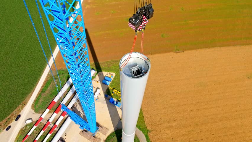 View From Above Of Wind Turbine Tower Erected With Lifting Crane At Farm Field In Austria. aerial orbit Royalty-Free Stock Footage #1107295075