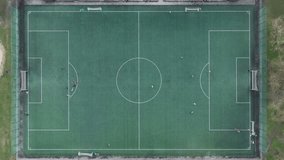 School football match seen from above.
Video footage of random people playing soccer.