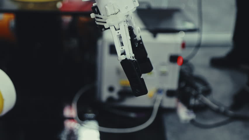 Industrial Robotics Engineer Expertly Programs a Hand with New Equipment. Robotic Arm Executes Tasks. Futuristic Technology. Precision Engineering | Shutterstock HD Video #1107297067