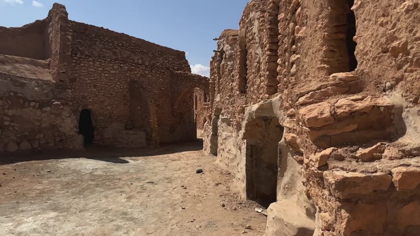Walking through remains of Ksar Hadada village in Tunisia | Shutterstock HD Video #1107298379