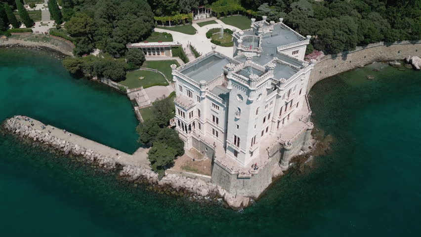 Drone pulls back and tilts up to reveal Italy Trieste, Miramare Castle