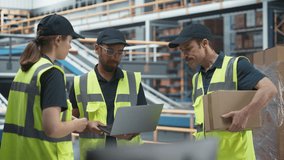 Diverse Team Of Warehouse Workers Having A Meeting In Logistics Facility With Conveyor Belt. Manager Using Laptop and Talking To Supervisor And Stocking Associate, Discussing Delivery Of Orders. - Powered by Shutterstock - Get 15% off with code: PIKWIZARD15