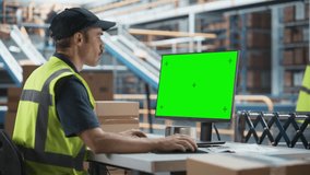 Caucasian Male Stocking Associate Using Green Screen Chromakey Desktop Computer In Modern Distribution Facility. Diverse Employees Working With Online Orders, Loading Cardboard Boxes On Conveyor Belt. - Powered by Shutterstock - Get 15% off with code: PIKWIZARD15