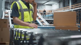 Caucasian Male Loader Putting Boxes On Automated Conveyor Belt In Modern Distribution Warehouse. Man In Reflective Work Jacket Loading Packages With Online Orders For Delivery To Customers. Low Angle. - Powered by Shutterstock - Get 15% off with code: PIKWIZARD15