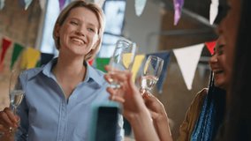 Happy team enjoy birthday party in modern office close up. Smiling relaxed coworkers holding wine glasses having fun together on event celebration. Cheerful colleagues dancing drinking champagne . - Powered by Shutterstock - Get 15% off with code: PIKWIZARD15