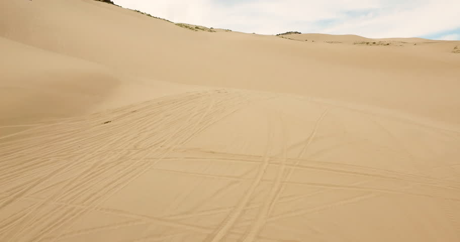 Drone Shot of Orange Dune Buggy Getting Long Air in Desert in Zion National Park Royalty-Free Stock Footage #1107300345