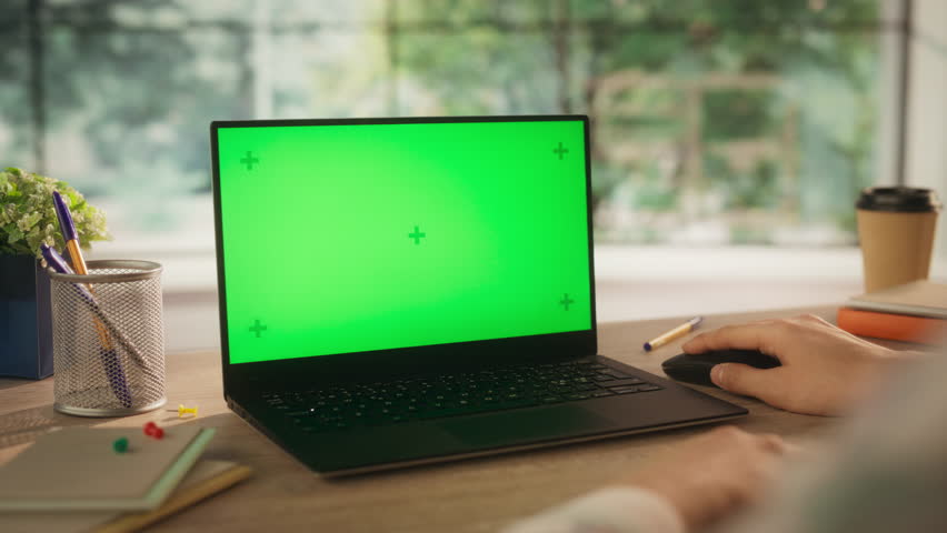 Anonymous Creative Project Manager Working on a Laptop Computer with Mock Up Green Screen Chromakey Display with Motion Tracker Placeholders. Video Template for Content Creation and Presentation
