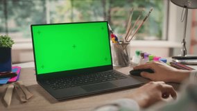 Anonymous Designer Working on a Laptop Computer with Mock Up Green Screen Chromakey Display with Motion Tracker Placeholders. Video Template for Artistic Content Creation and Presentation