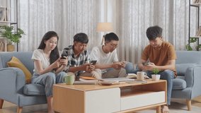 Asian Teen Group With Books And A Laptop Using Smartphone, Break Time After Studying At Home
