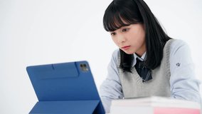 Asian school girl studying with a tablet PC. Online school. Remote class.