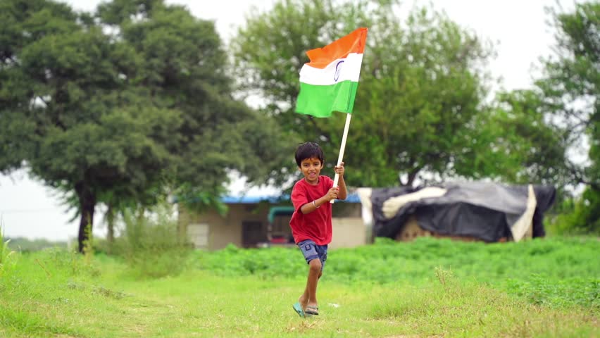 Cute little Indian kids holding, waving or running with Tricolour with greenery in the background, celebrating Independence or Republic day