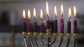 During Hanukkah celebration in time honored tradition of lighting hanukkiah menorah candles, symbolizing triumph light over darkness. - Powered by Shutterstock - Get 15% off with code: PIKWIZARD15