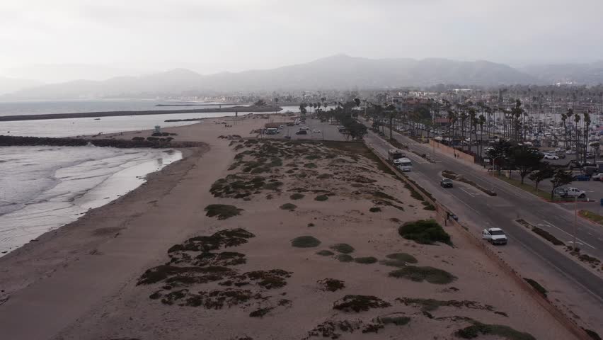 Low aerial shot flying over sand dunes towards the Channel Islands National Park Visitor Center in Ventura, California. 4K