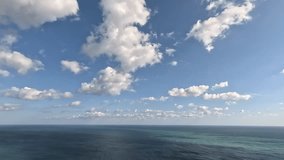 Timelapse fluffy Cumulus clouds moving in bright sunset sky over calm sea. Abstract aerial nature summer ocean sunset, sea and sky view. Vacation, travel, holiday concept. Weather and Climate Change. - Powered by Shutterstock - Get 15% off with code: PIKWIZARD15