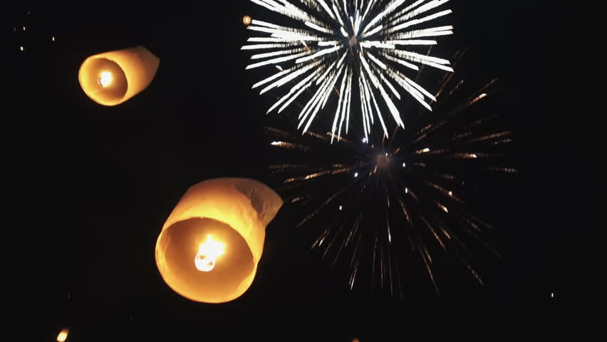 Sparkling Skies: A Spectacular Display of Fireworks and Lanterns. Amazing lanterns of light is released into the night sky by multi ethnic crowd. Celebrate lantern festival of light in Yeepeng festive Royalty-Free Stock Footage #1107310043