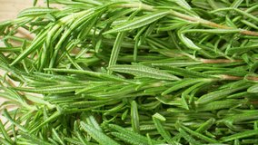 Versatile and aromatic rosemary: culinary, medicinal, ornamental uses. Its unique flavor and scent make it popular worldwide, easily grown in gardens and adored in kitchens. Rosemary background. 4K
