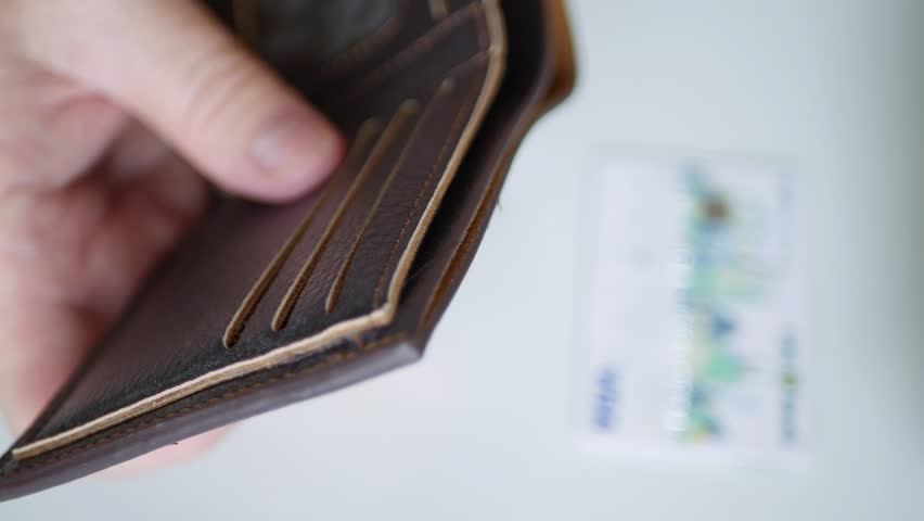 Blurred Shooting with a Businessman Putting a Credit Card in the Wallet. Financial Investments Business Concept. Man Using a Banking Card for Tax Payments. Royalty-Free Stock Footage #1107322151