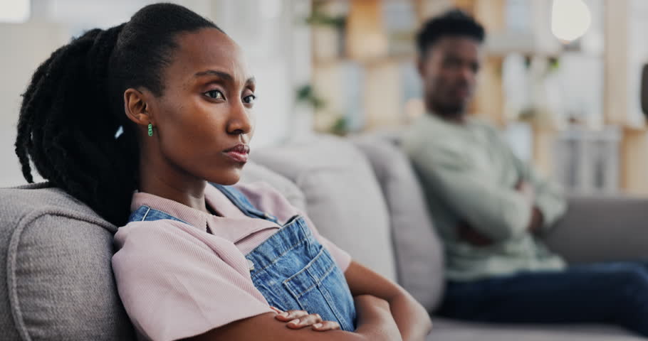 Sofa, angry and black woman in a fight with a man for divorce, fail and thinking of conflict. House, sad and an African couple on the couch with marriage stress, problem or frustrated with mistake Royalty-Free Stock Footage #1107327365
