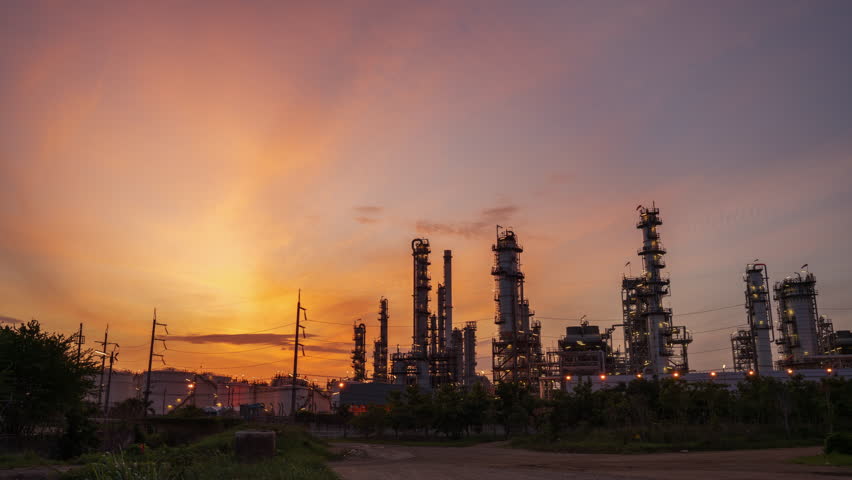 Time Lapse Oil Refinery plant at sunset. Gas Chemical Equipment Prodiction import export Concept, Crude Oil Refinery Plant Steel Pump Pipe line and Chimney and Cooling tower, Chemical Petrochemical 
