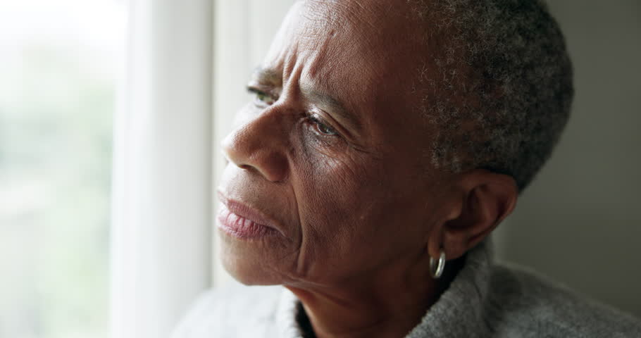 Window, thinking and old woman with depression, sad and mental health with anxiety, remember and memory. Elderly person, nostalgia or pensioner with grief, home or feeling lonely with loss or retired Royalty-Free Stock Footage #1107335573