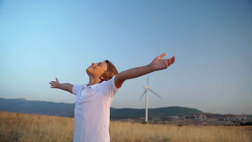 Relaxed teen boy breathing fresh air raising arms over blue sky sunset twilight at summer. Dreaming, freedom and traveling concept. Royalty-Free Stock Footage #1107336691